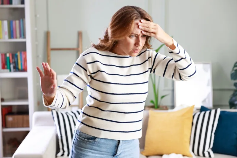young woman suffering from vertigo or dizziness problem of brain or inner ear