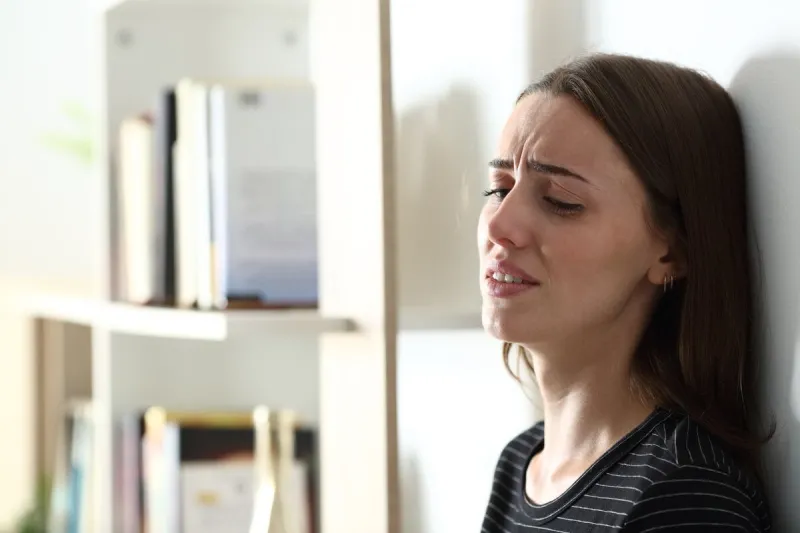 depressed woman crying alone at home
