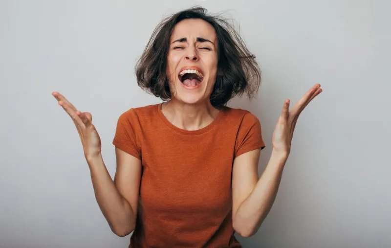 close up shot of screaming crazy frustrated woman with anxiety, anger and depression very upset and emotional woman crying young girl with angry and furious face human expressions and emotions