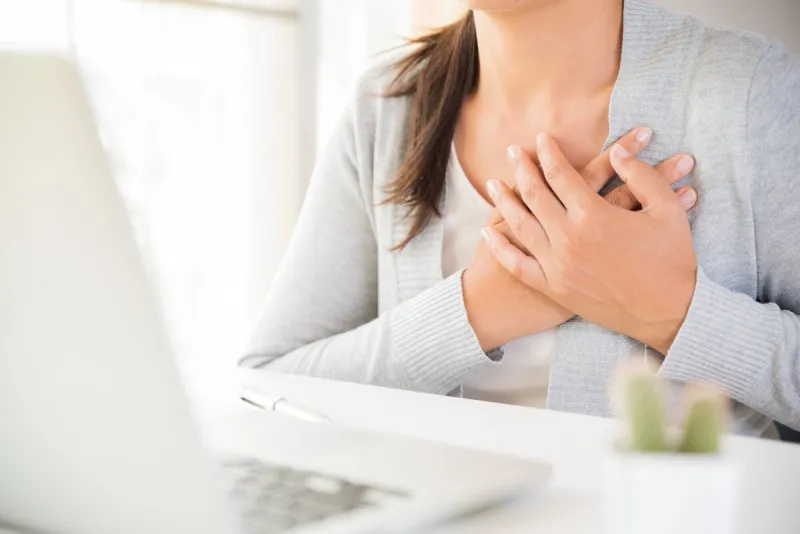 closeup business woman having heart attack woman touching breast and having chest pain after long hours work on computer office syndrome, healthcare and medical concept
