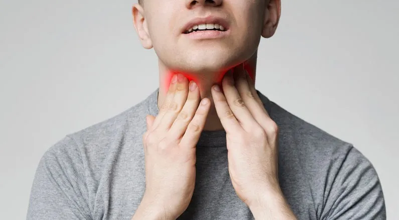 breathing problem young man pulping his inflamed neck, close up
