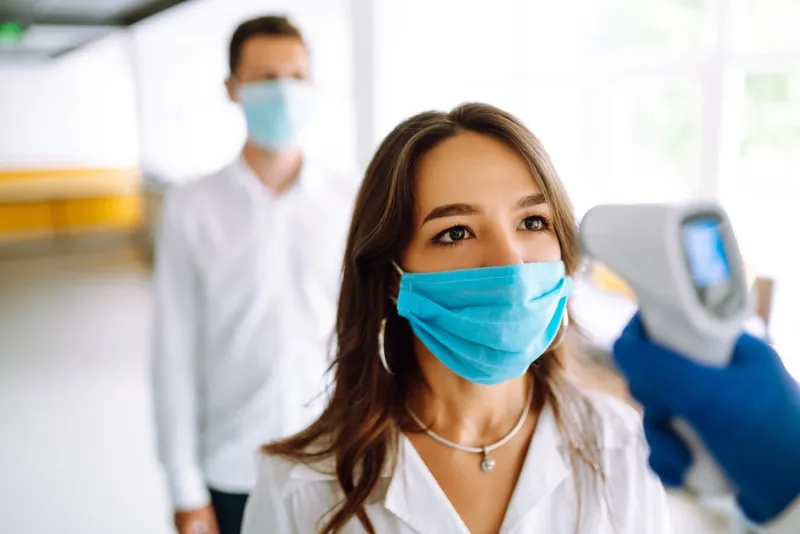 visitors must go through fever measures using infrared digital thermometer check temperature measurement on the forehead covid-19, quarantine or virus outbreak concept