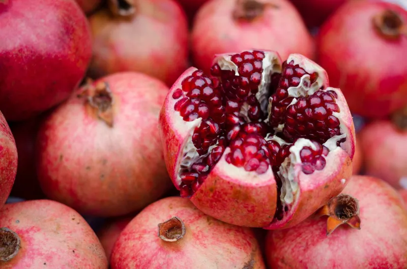 natural background of sweet fresh coral red pomegranate ripes, group of pomegranates pomegranate closeup, background