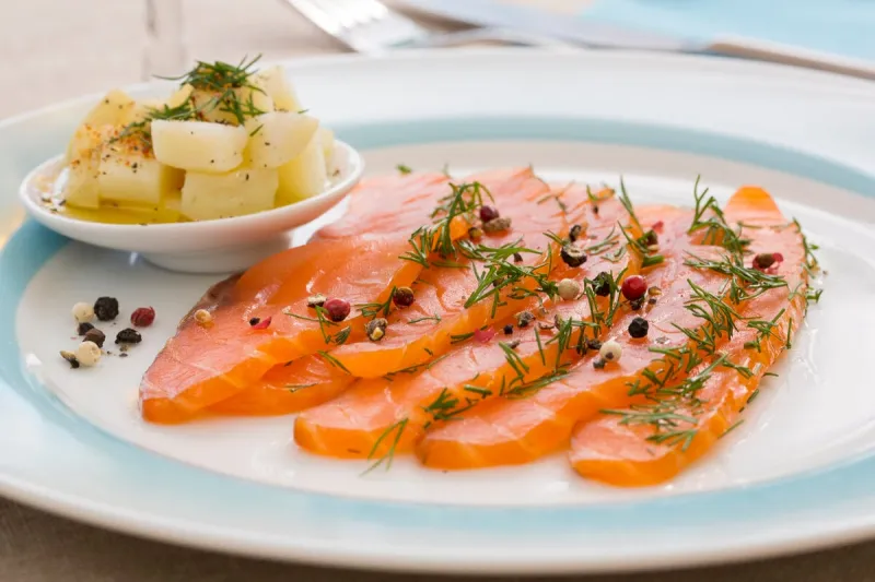 smoked salmon and ingredients in plate on table