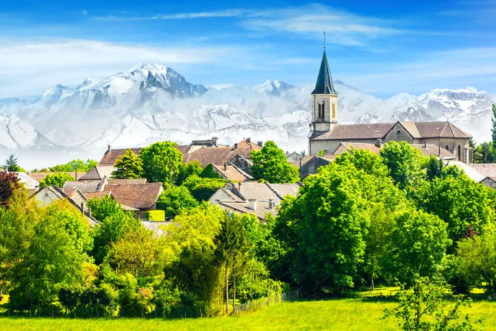old french village in countryside with mont blanc alps mountains