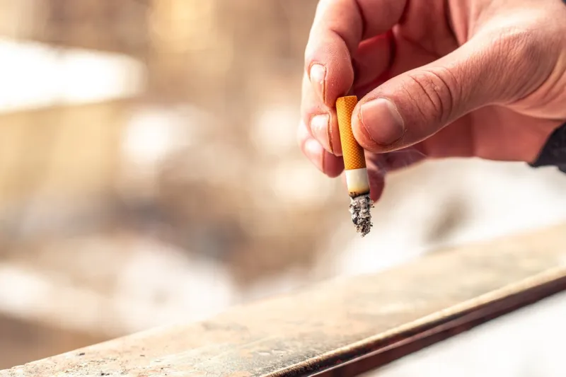 male hands holding cigarette butt cigarettes smoking concept high quality photo close-up of a cigarette butt human health concept copy space