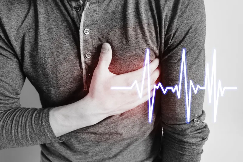 the guy holds the patient's hand on his chest chest pain pain location is marked in red