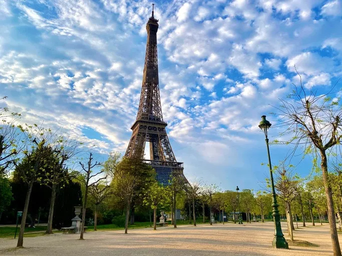 scenic view of the eiffel tower with bright blue sky in paris, france empty parisian streets during coronavirus quarantine and lockdown popular tourist destinations