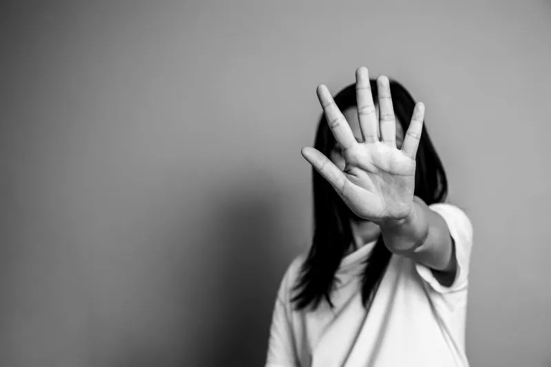 woman raised her hand for dissuade, campaign stop violence against women asian woman raised her hand for dissuade with copy space, black and white color