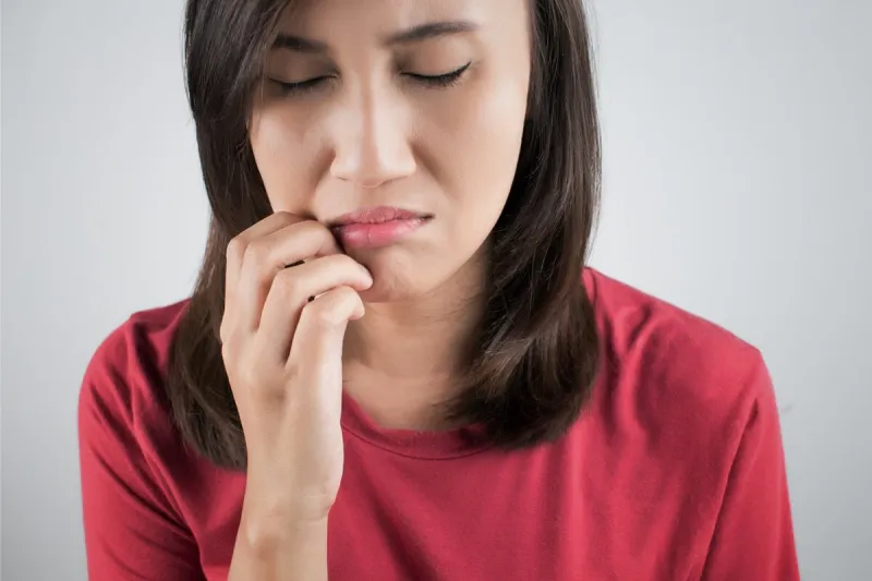 woman scratching her mouth on white background
