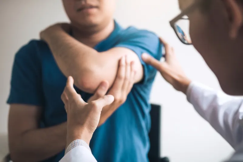 physical therapists are checking patients elbows at the clinic office room