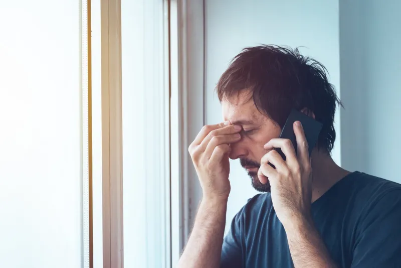 unpleasant phone call, worried anxious man talking with someone on mobile phone