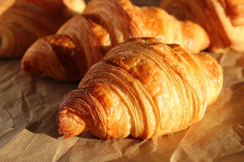 freshly backed french croissants shiny in the rays of the mornin