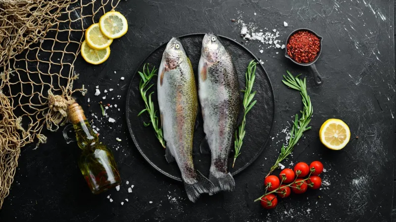 raw fish trout on a plate top view free space for your text