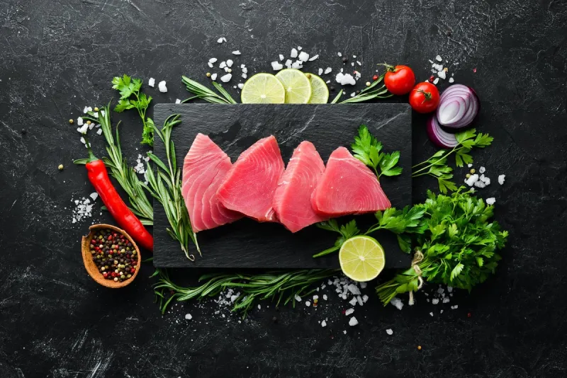 raw tuna fillet seafood on a black stone background top view free copy space