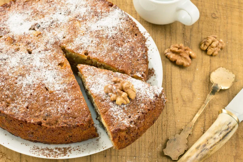 close up view of a walnut pie on a wooden board