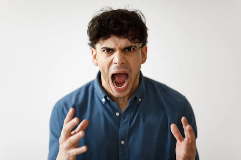 aggression portrait of angry middle eastern man shouting loudly expressing negative emotions looking at camera posing over white studio background mad guy yelling at you mental health problems