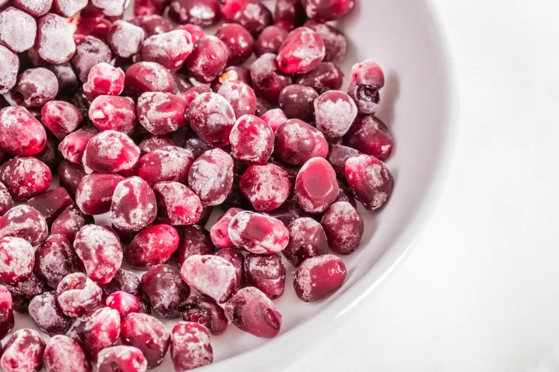 frozen pomegranate on white background