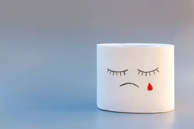 toilet paper and blood concept of hemorrhoid treatment