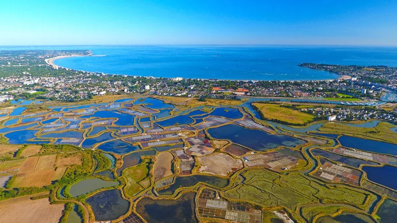 an aerial view of la baule from guerande salt marshes