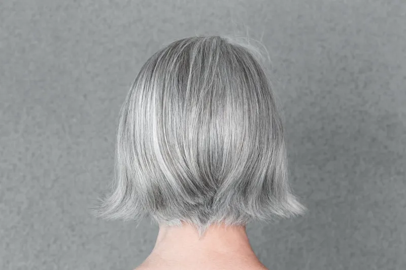 woman with beautiful natural gray hair, from behind