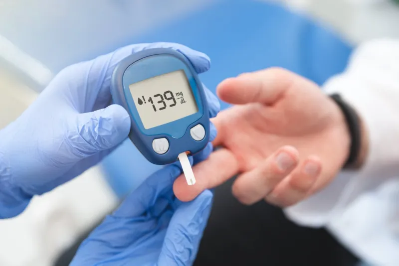doctor using glucometer, blood glucose test diabetes concept