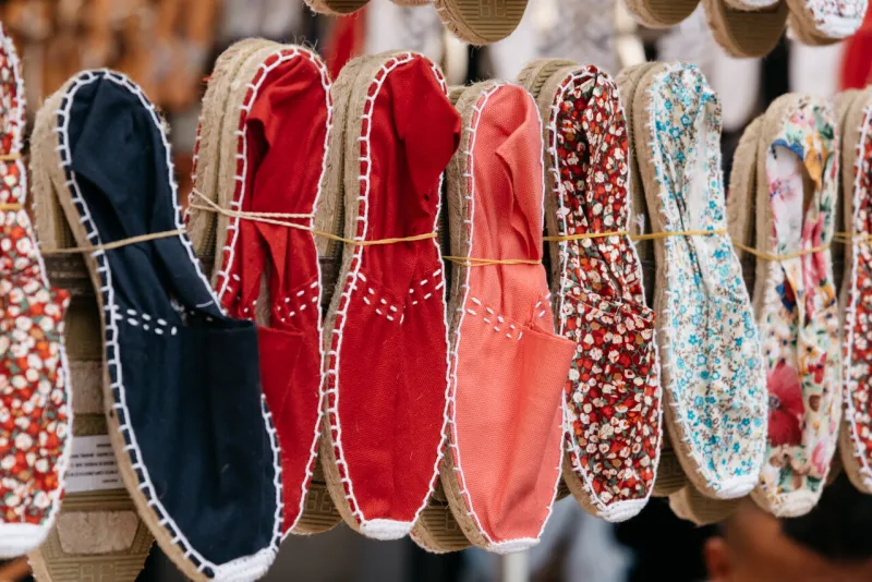 colorful spanish handmade rope soled sandals or espadrilles in market stall