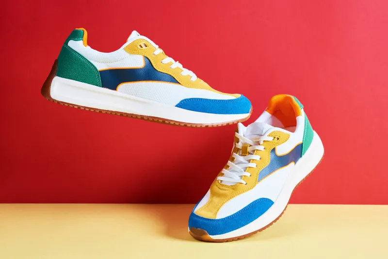 flying trendy sneakers on creative colorful background, stylish fashionable minimalism concept, levitation shoes