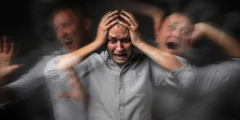 man having panic attack on dark background