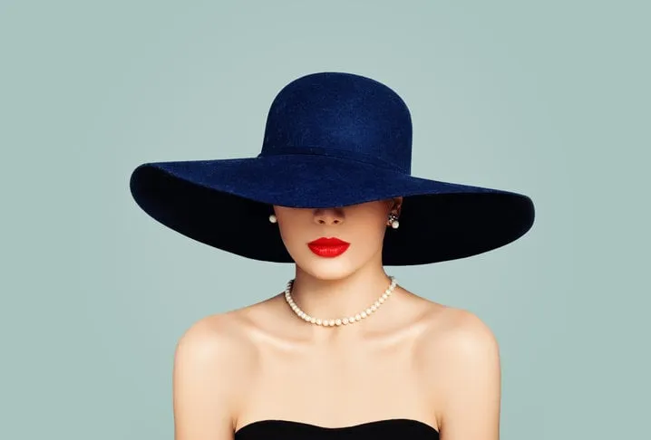 elegant woman fashion model with red lips makeup wearing classic hat and white pearls, portrait