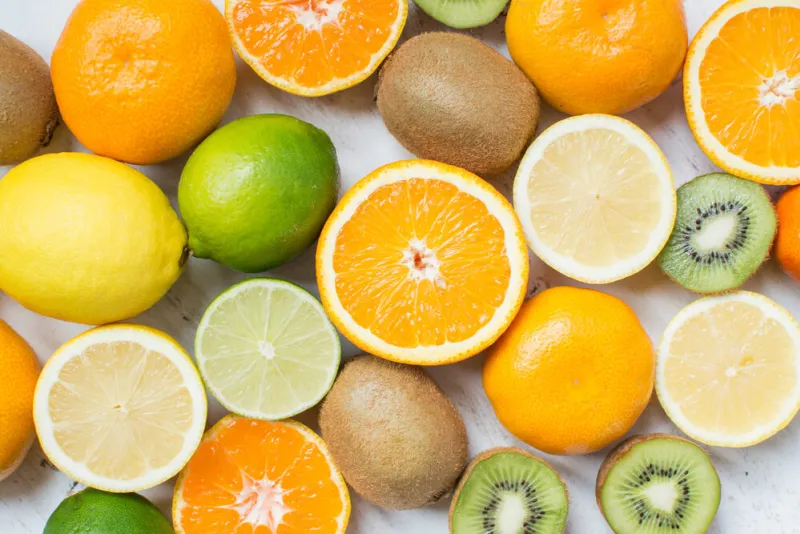 fruits reach in vitamin c  oranges, lemons, limes, clementines, kiwis, top view, selective focus