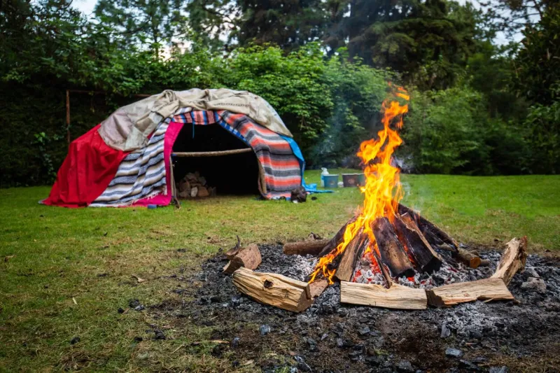 traditional native sweat lodge with hot stones inside
