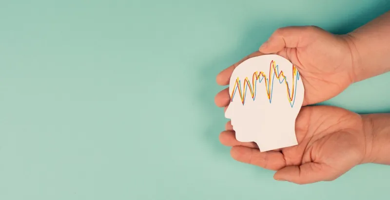 holding a head in the hands, mental health concept, alzheimer and epilepsy disorder, brain waves, paper cut out