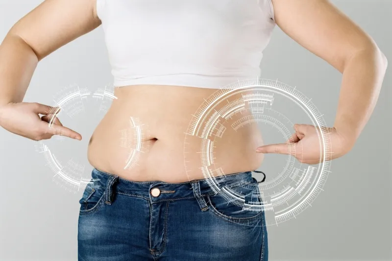 skinny fat woman figure touches stomach abdominal fat and dieting concept massaging marks