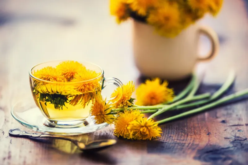 cup of dandelion tea on rustic wooden table