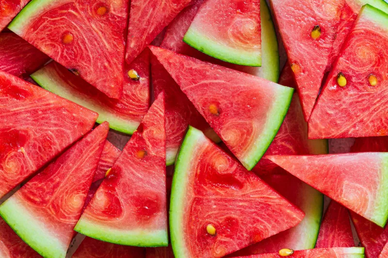macro sliced watermelon,red watermelon triangular piece on white blackground