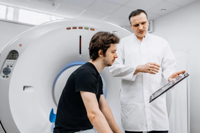 a dedicated doctor completes an mri examination while engaging with a patient this image showcases professionalism and compassion in healthcare—ideal for medical ads highlighting advanced technology