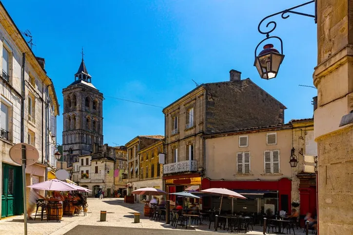 central street of french town of cognac overlooking bell tower of saint leger church