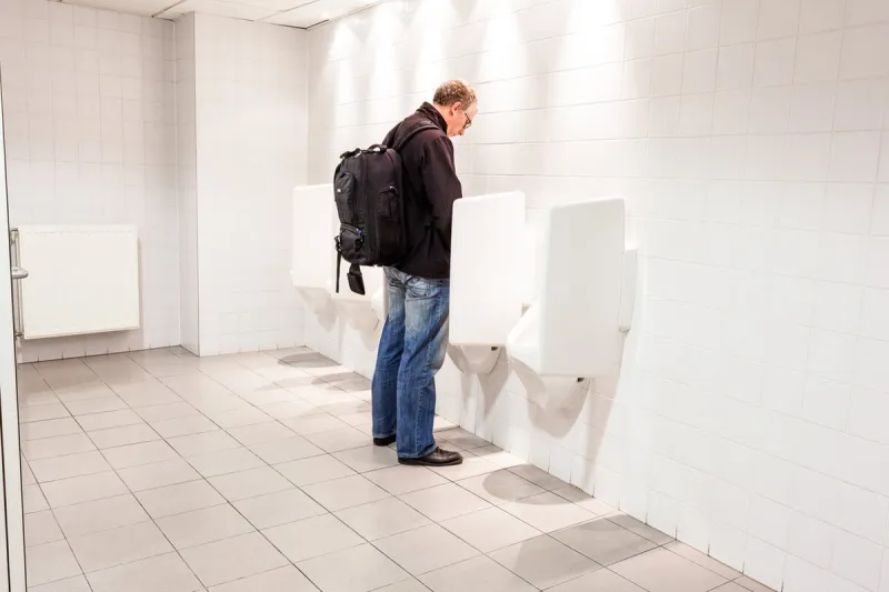 urinals in an old building for men only