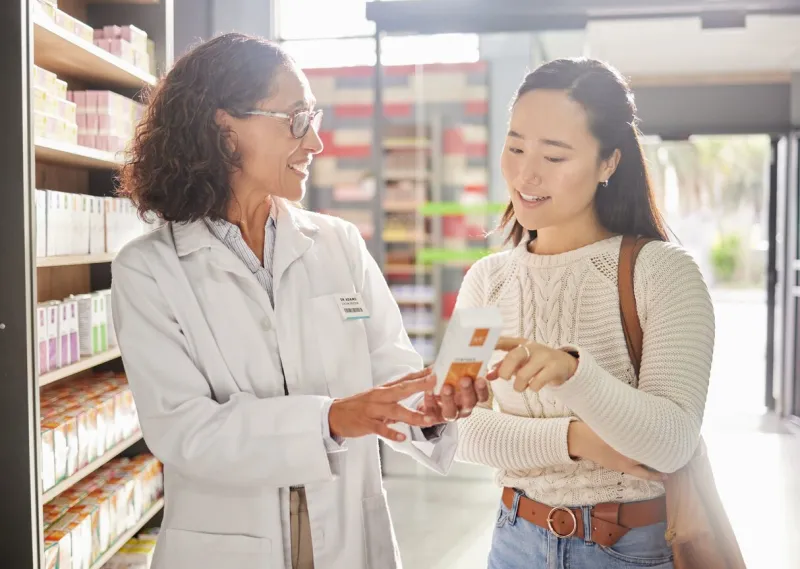 asian woman, medicine shopping or pharmacist in pharmacy for retail healthcare product information women or friendly doctor helping a customer with store medication advice, pills or medical drugs