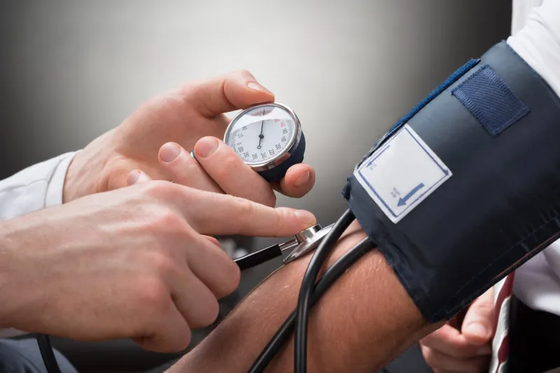close-up of a doctor's hand checking blood pressure of a patient