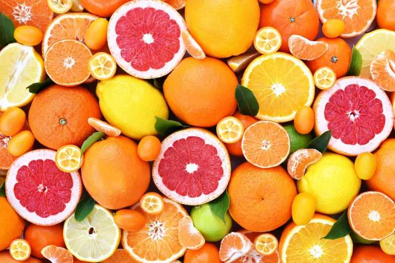colorful bright background of fresh ripe sweet citrus fruits  orange and red grapefruit, green lime and yellow lemon, tangerine and kumquat
