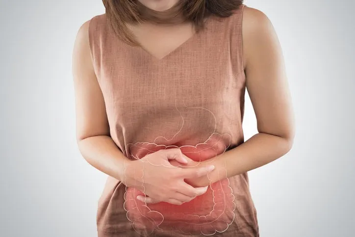 the photo of large intestine is on the woman's body people with stomach ache problem concept female anatomy