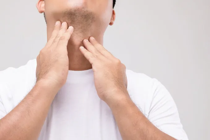 lymphoma in men concept   portrait asian man is touching on his neck at lymph node position studio shot isolated on grey background