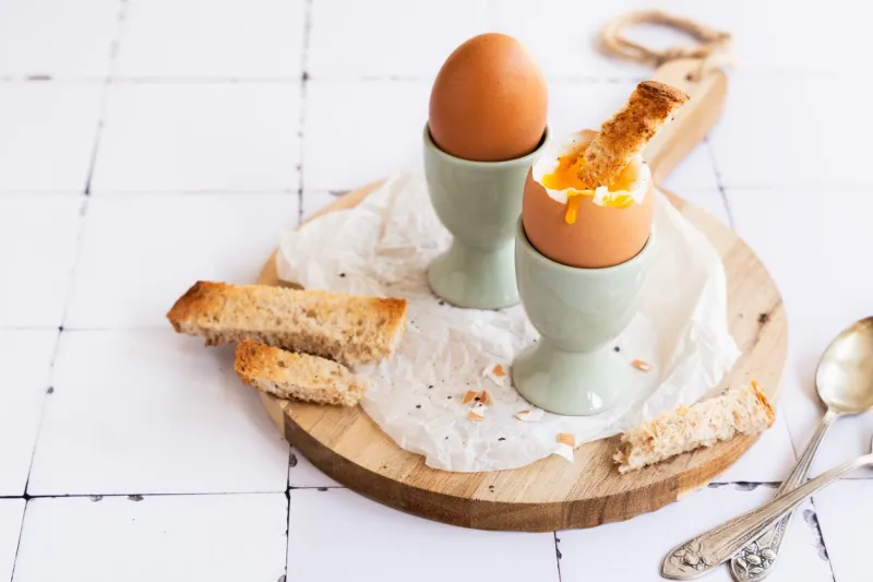 boiled chicken eggs with toasted bread on egg cup healthy food copy space