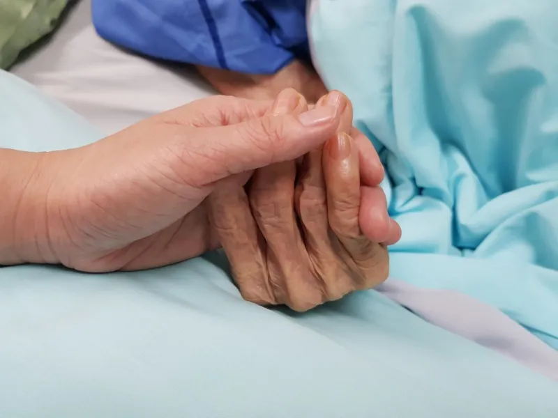 holding grandmother's hand in the nursing care showing all love, empathy, helping and encouragement   healthcare in end of life and palliative concept