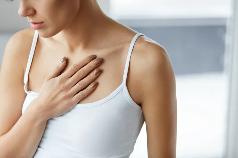 heart health care closeup of young woman feeling strong pain in chest close-up of female body with hand on chest girl suffering from painful feeling, having health issues high resolution image