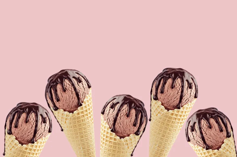 chocolate ice cream in crisp waffle cones with sweet brown sauce as border on pink background, mock up