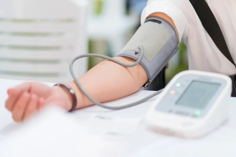 doctor checking patient arterial blood pressure in hospital health care concept