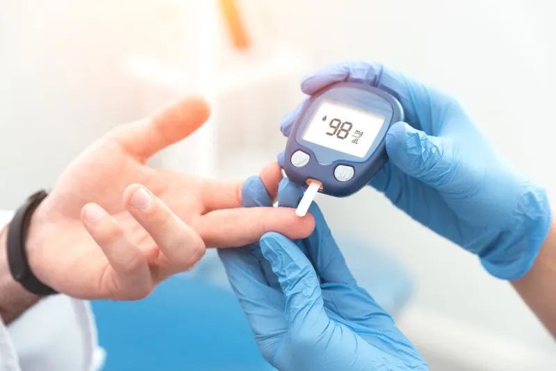 doctor checking blood sugar level with glucometer treatment of diabetes concept